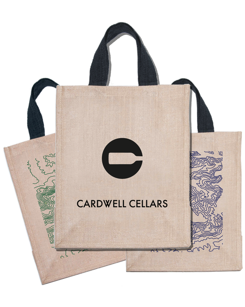 Two beige tote bags with Cardwell Cellars branding on a beige background
